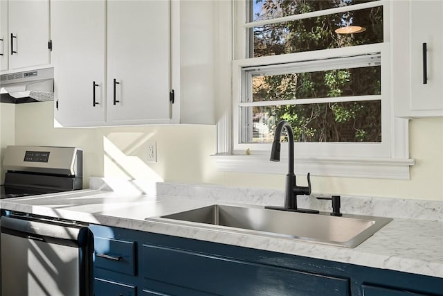 kitchen with white cabinetry, sink, stainless steel stove, and blue cabinets