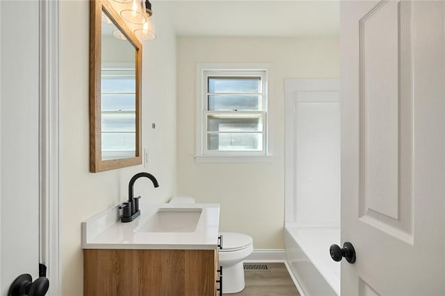 bathroom featuring hardwood / wood-style floors, vanity, and toilet