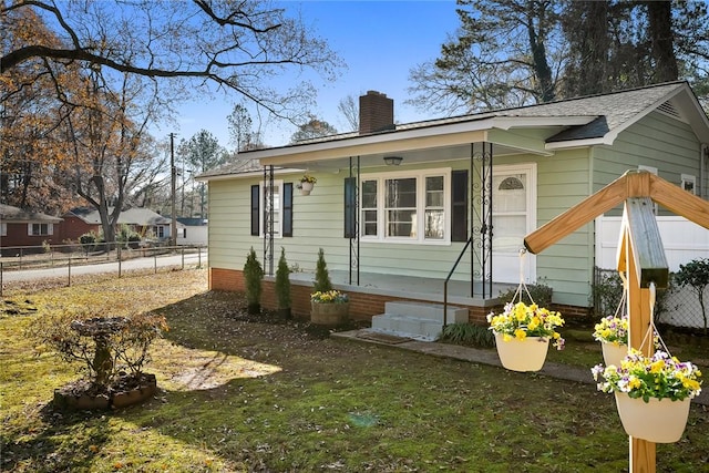 rear view of property featuring a yard