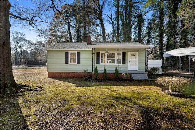 view of front of house with a carport, a porch, and a front yard