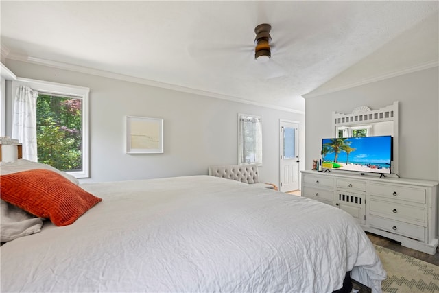 bedroom featuring wood-type flooring, lofted ceiling, ceiling fan, and crown molding