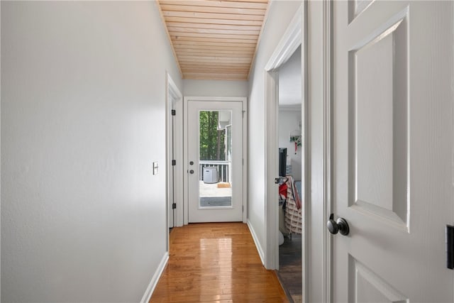 doorway featuring light hardwood / wood-style floors and wood ceiling