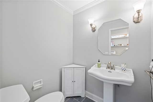 bathroom featuring tile patterned flooring, ornamental molding, and toilet