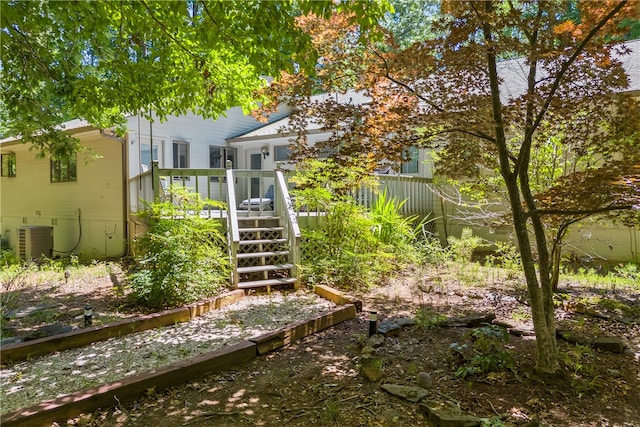 view of yard featuring central AC unit and a wooden deck