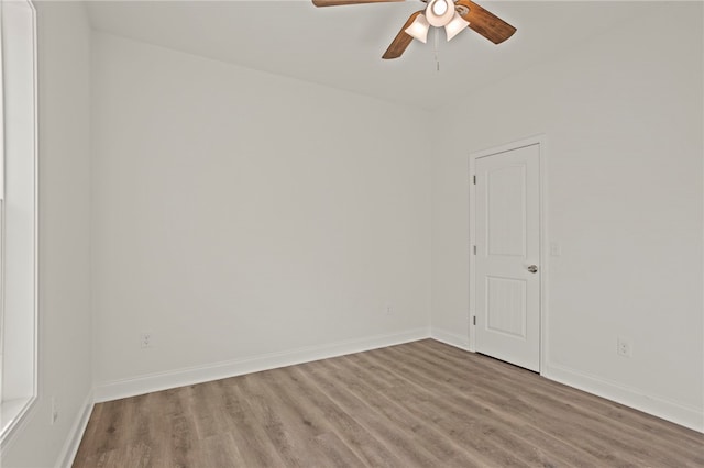 spare room with ceiling fan and light wood-type flooring