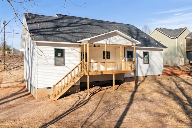 rear view of property featuring ceiling fan and a porch