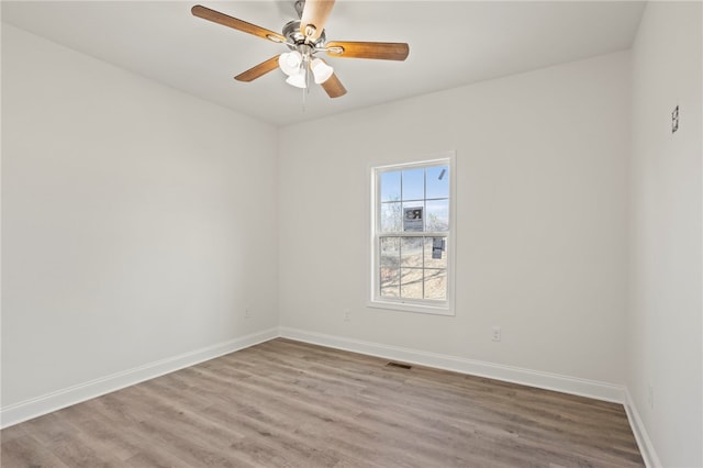 empty room with ceiling fan and wood-type flooring