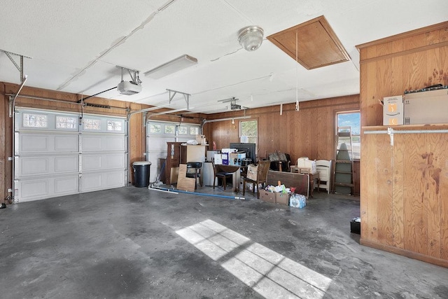 garage featuring wood walls and a garage door opener