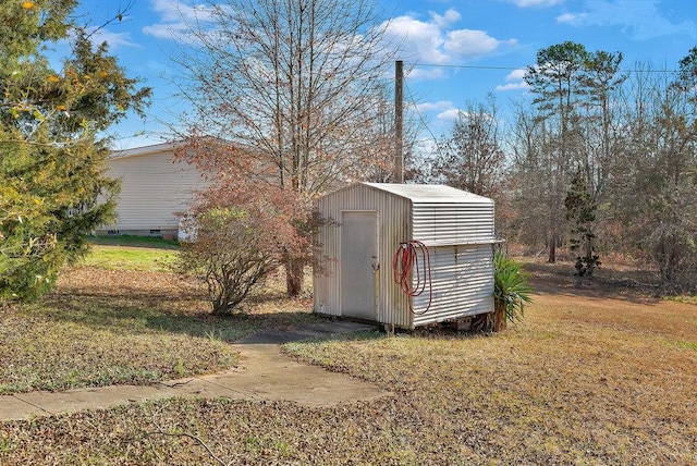 view of outbuilding featuring a lawn