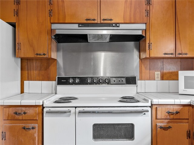 kitchen featuring tile countertops and white appliances