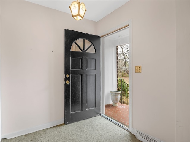 entrance foyer featuring carpet flooring and a chandelier