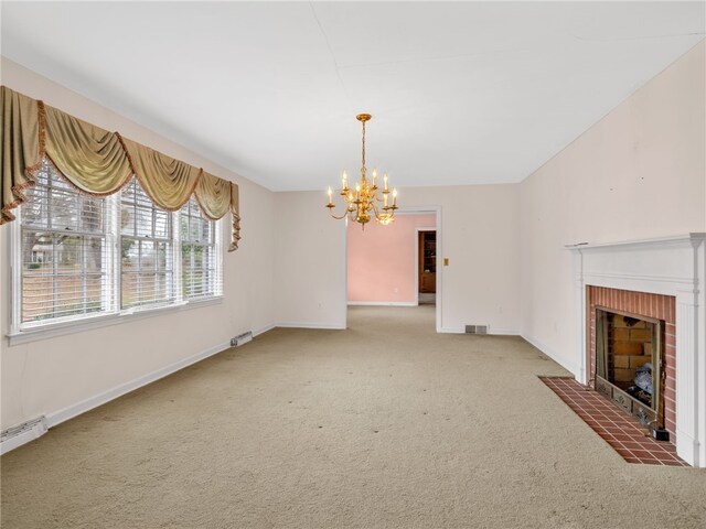 unfurnished living room featuring an inviting chandelier, carpet, a baseboard heating unit, and a brick fireplace