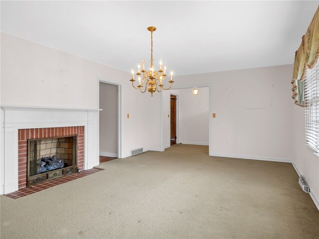 unfurnished living room featuring carpet flooring, a brick fireplace, and an inviting chandelier