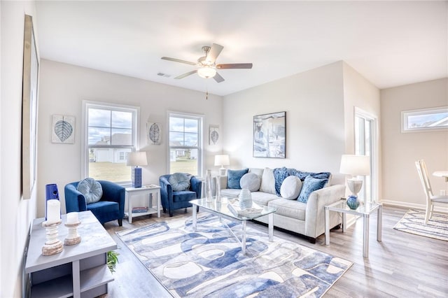 living room with ceiling fan and light wood-type flooring