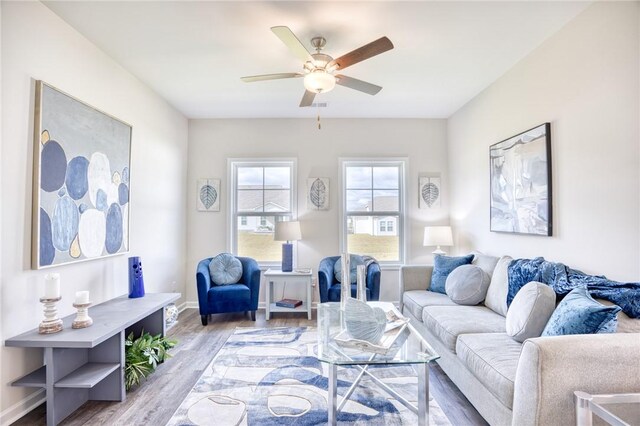 living room with ceiling fan and light wood-type flooring