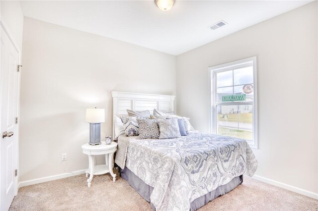 carpeted bedroom featuring multiple windows