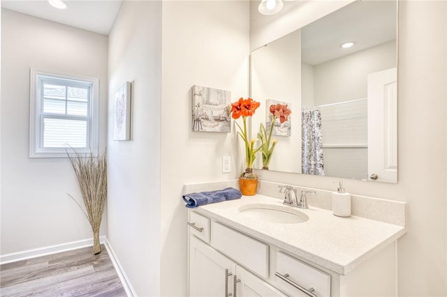 bathroom with vanity and hardwood / wood-style flooring