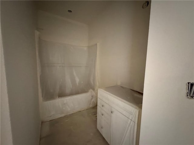 full bath featuring shower / bathtub combination with curtain and concrete flooring