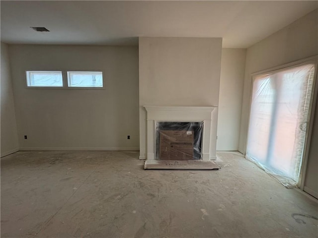 unfurnished living room with a fireplace and visible vents