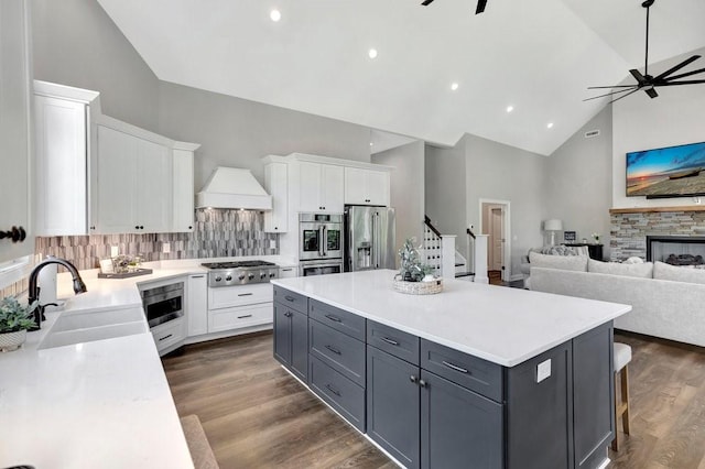 kitchen with sink, gray cabinets, appliances with stainless steel finishes, tasteful backsplash, and white cabinetry