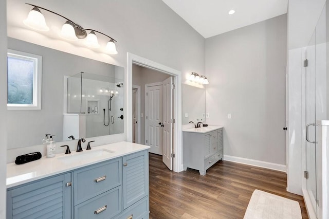 bathroom featuring vanity, hardwood / wood-style flooring, and a shower with shower door