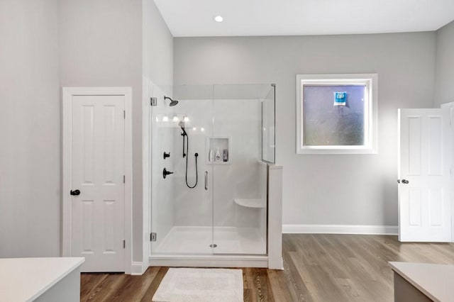 bathroom featuring vanity, wood-type flooring, and a shower with shower door