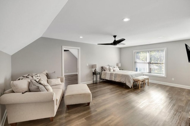 bedroom with ceiling fan, dark wood-type flooring, and lofted ceiling