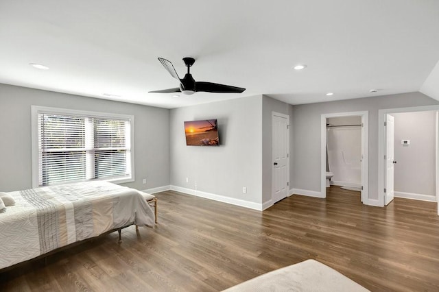 bedroom with ceiling fan, dark hardwood / wood-style flooring, and connected bathroom