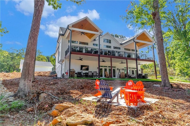 back of property featuring ceiling fan, french doors, and a balcony