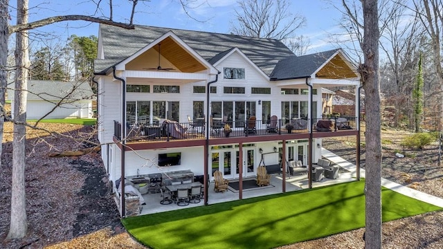 rear view of house with french doors, a yard, a patio area, and a wooden deck