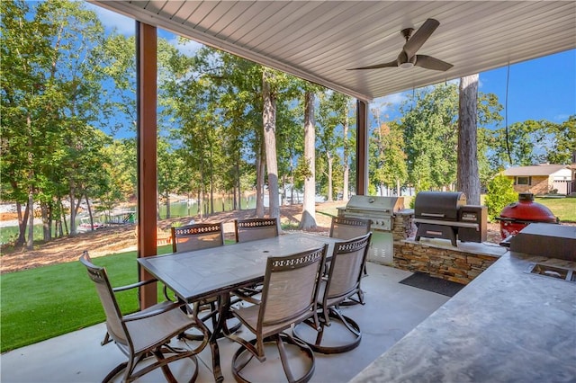 view of patio with grilling area, ceiling fan, and exterior kitchen