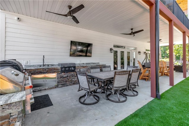 view of patio with an outdoor hangout area, sink, ceiling fan, a grill, and exterior kitchen