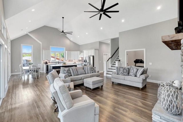 living room with ceiling fan, high vaulted ceiling, and hardwood / wood-style flooring