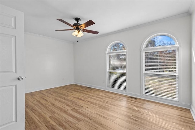 unfurnished room featuring ceiling fan, light hardwood / wood-style floors, and ornamental molding