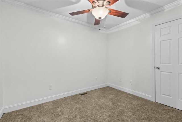 carpeted spare room featuring ceiling fan and crown molding