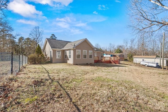 back of house with a yard and a wooden deck