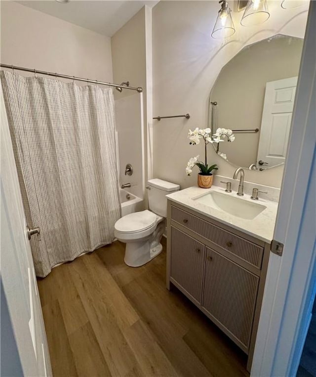 full bathroom featuring shower / bath combination with curtain, toilet, wood-type flooring, and vanity