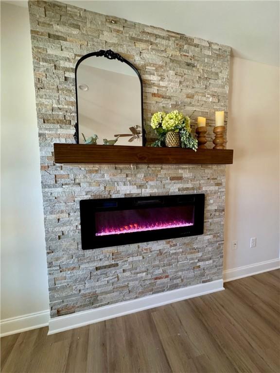 details with a fireplace and wood-type flooring