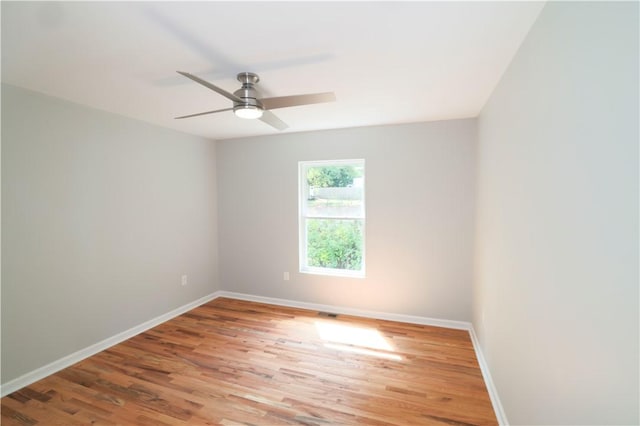 spare room featuring hardwood / wood-style floors and ceiling fan