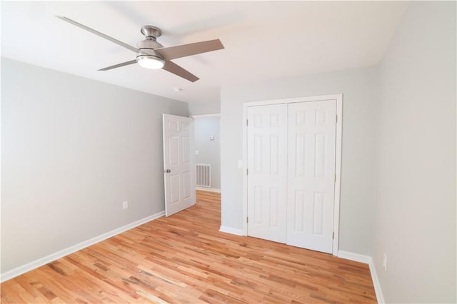 unfurnished bedroom with a closet, light hardwood / wood-style flooring, and ceiling fan