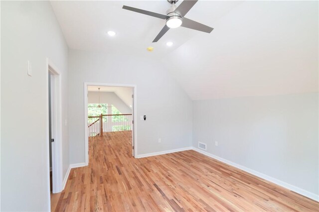 additional living space featuring light wood-type flooring, vaulted ceiling, and ceiling fan