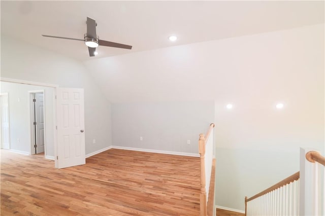 bonus room with ceiling fan, light hardwood / wood-style floors, and vaulted ceiling