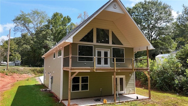 rear view of house featuring a yard, a patio, and french doors