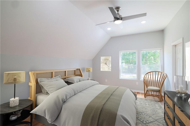 bedroom featuring ceiling fan, hardwood / wood-style floors, and lofted ceiling