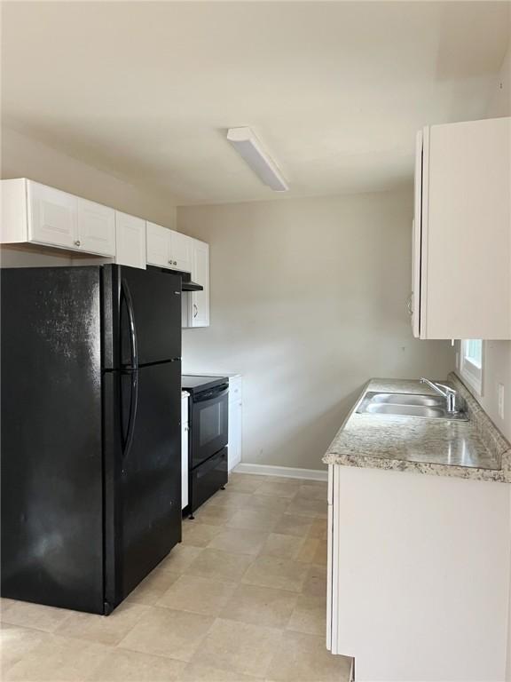 kitchen featuring white cabinets, sink, and black appliances