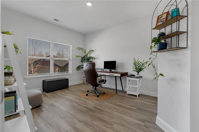 office space with light hardwood / wood-style flooring