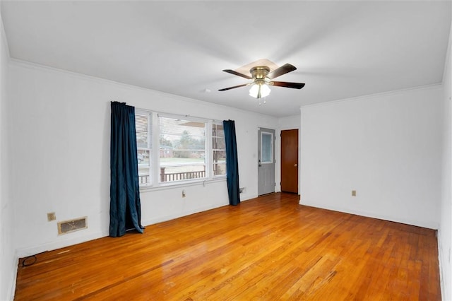 empty room featuring light hardwood / wood-style floors, ceiling fan, and crown molding