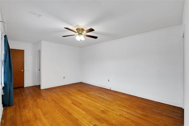 unfurnished room featuring hardwood / wood-style flooring, ceiling fan, and crown molding