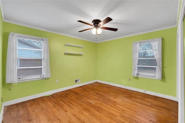 spare room with light wood-type flooring, ceiling fan, and ornamental molding