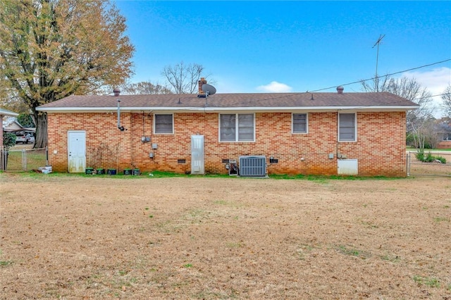 rear view of house featuring a yard and cooling unit